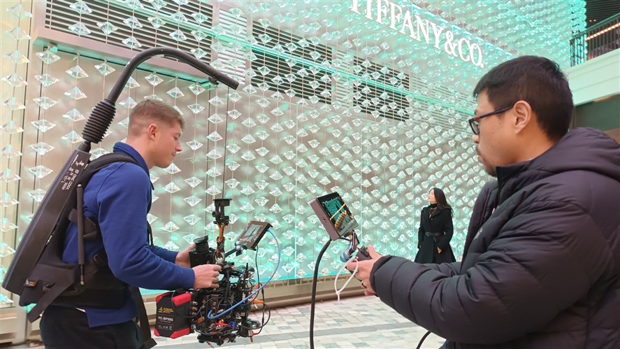 Beijing production crew preparing camera and lighting gear inside a stylized interior location